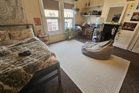 Bright and spacious master bedroom featuring a ...