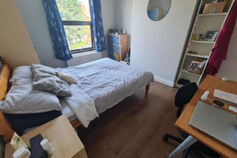 A bright and cozy double bedroom featuring a co...