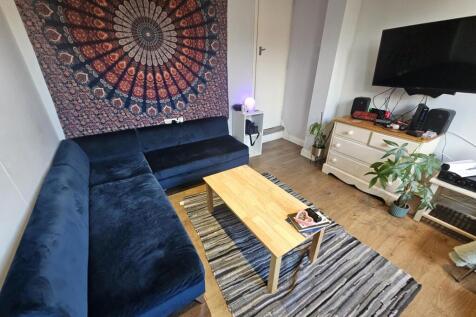 A cozy living room featuring a large dark blue ...