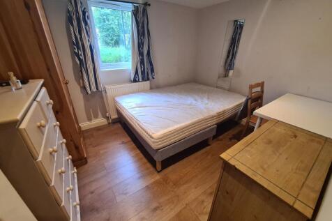 A cozy double bedroom featuring natural light f...