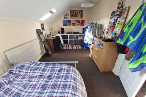 A spacious and bright bedroom featuring a doubl...