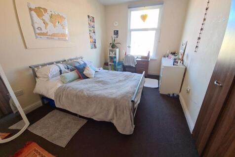 A bright and inviting master bedroom featuring ...