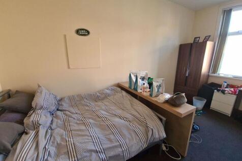 A comfortably furnished bedroom featuring a dou...