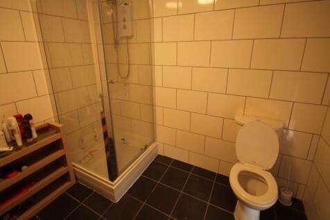 A modern bathroom featuring a large shower encl...