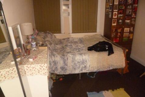 A compact bathroom with basic fixtures, featuri...