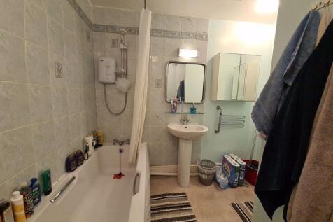 A well-maintained bathroom featuring a bathtub,...