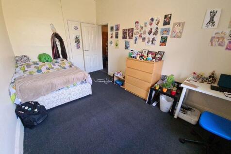 A cozy and well-maintained bedroom with a comfo...