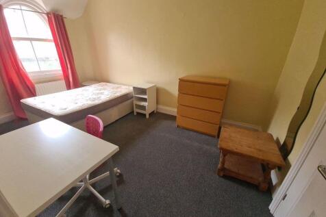 A modest single bedroom with a window allowing ...