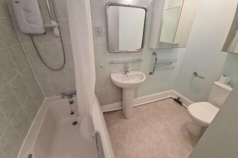 A well-maintained bathroom featuring a large sh...