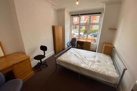 A bright and tidy double bedroom featuring a co...