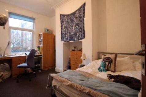 A cozy and inviting master bedroom featuring a ...