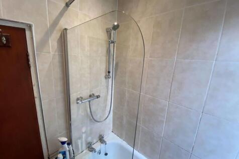 A modern bathroom suite featuring a clean white...