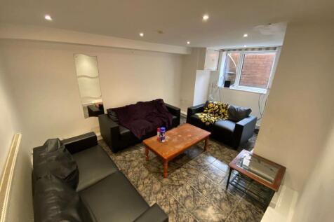 A cozy communal lounge featuring a mix of comfo...