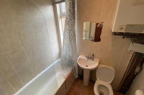 A compact bathroom suite featuring a full batht...