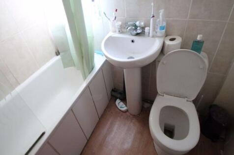 A clean and modern bathroom featuring a white s...