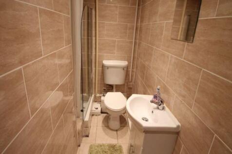 A clean and modern bathroom featuring tiled wal...