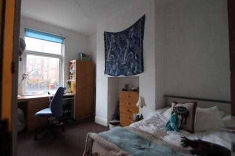 Cozy single bedroom featuring a comfortable bed...