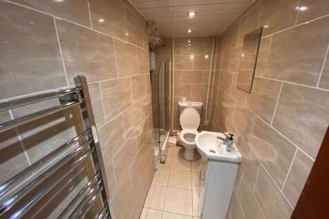 A modern bathroom featuring sleek tiled walls a...