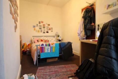 A cozy, well-organized bedroom featuring a sing...