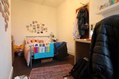 Cozy and well-kept bedroom featuring a comforta...