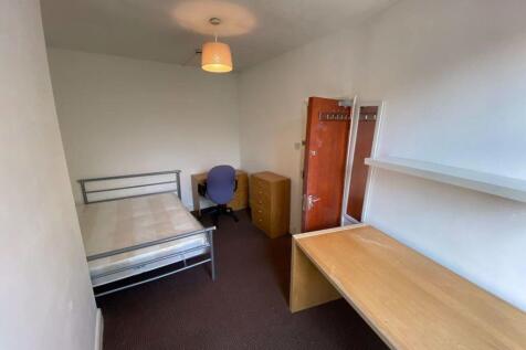 A tidy and simple single bedroom featuring a me...