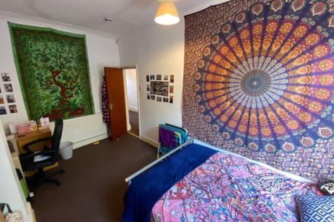 A tidy and well-lit single toilet room featurin...