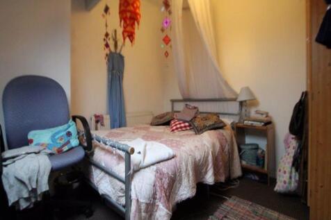 Cozy single bedroom featuring a comfortable bed...