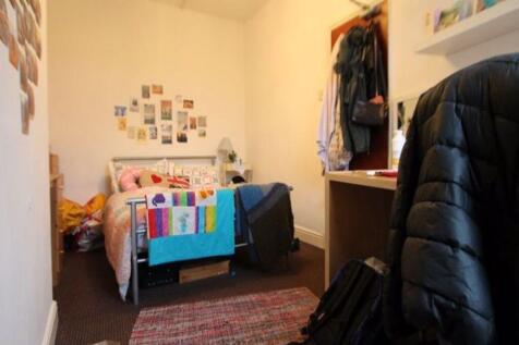 Cozy and personalized bedroom featuring a comfo...