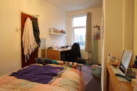 Cozy and functional bedroom featuring a comfort...