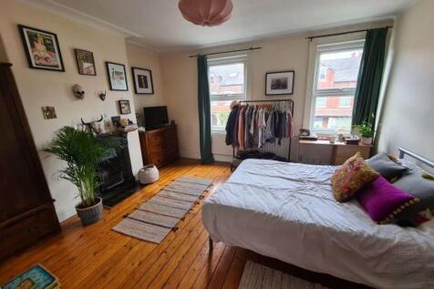 A bright and welcoming living room featuring la...