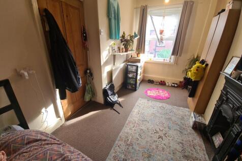 A cozy bedroom with natural light streaming thr...