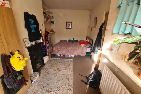 A spacious and well-lit master bedroom featurin...