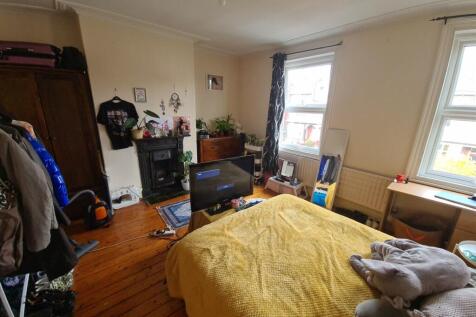 A spacious and inviting living room featuring a...