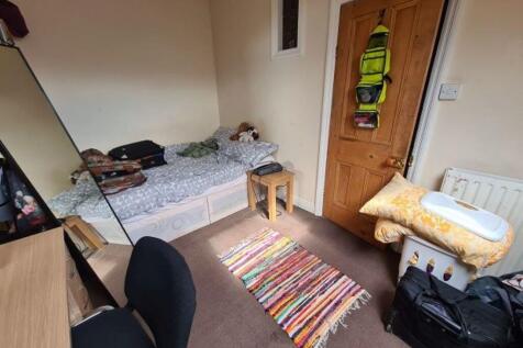 A small bathroom with a toilet, featuring basic...