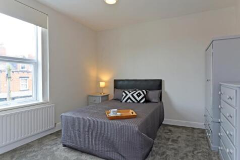 A cozy and well-lit double bedroom featuring a ...