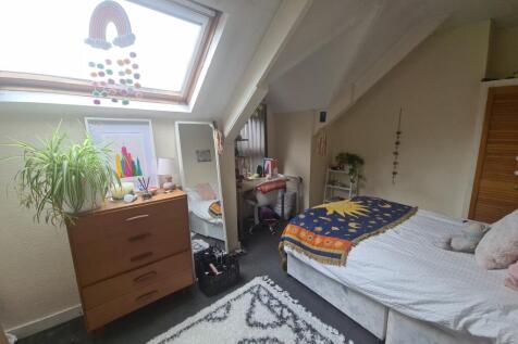 Bright and cozy double bedroom featuring a comf...
