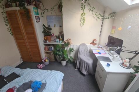 Cozy single bedroom featuring a skylight window...