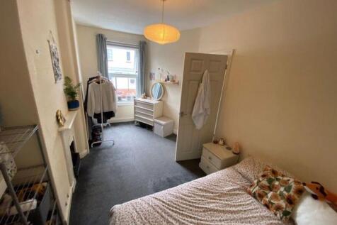 A clean and bright single toilet room with natu...