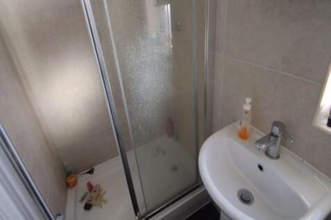 A neat and modern bathroom featuring a compact ...