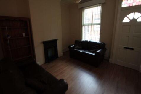 A cozy living room featuring two dark-colored s...