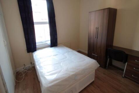 A tidy bedroom with a comfortable double bed, a...