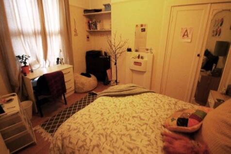 Cozy and inviting master bedroom featuring a co...