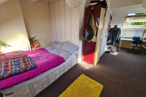 Bright and cozy master bedroom featuring a comf...
