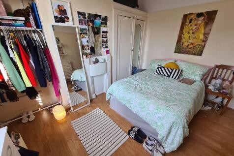 A cozy and well-organized double bedroom featur...