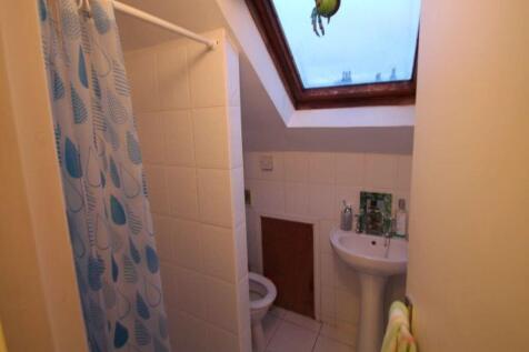 A compact and clean bathroom featuring a tiled ...