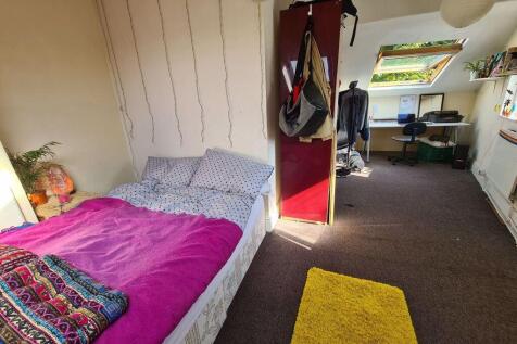 Cozy single bedroom featuring a comfortable bed...