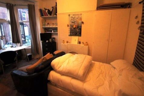 Cozy single bedroom featuring a comfortable bed...