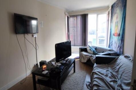 A spacious and well-lit living room featuring m...