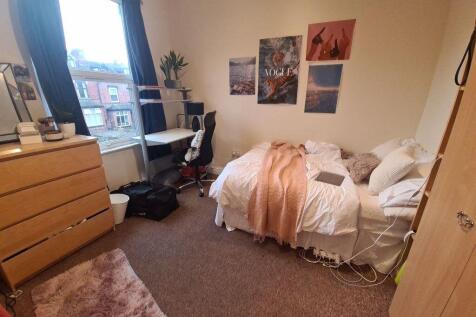 A cozy bedroom featuring a comfortable bed with...