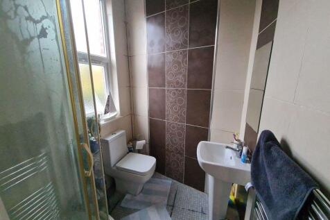 A clean and well-lit bathroom featuring a toile...